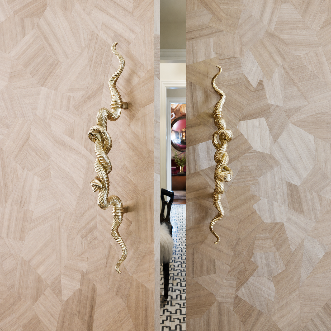 Hand-cast brass Double Snake Pull by Lisa Jarvis installed on inlaid wood doors, New York Hardware