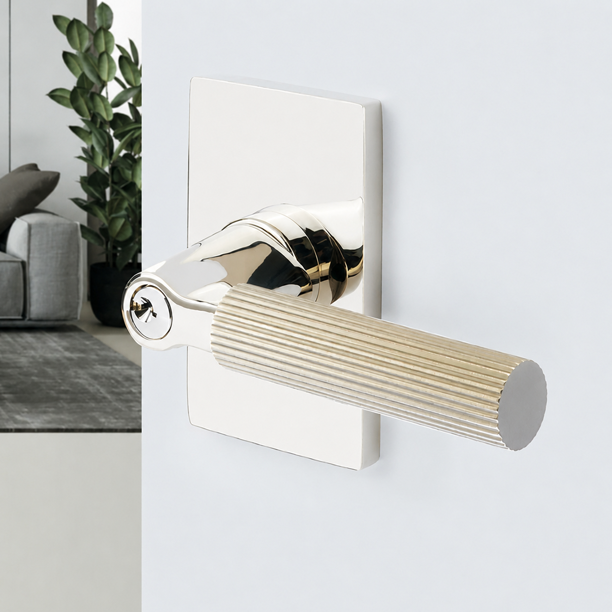 A polished nickel keyed entry lever with a fluted grip on a rectangular rosette, mounted on a white door, with the key cylinder visible at the base of the lever.